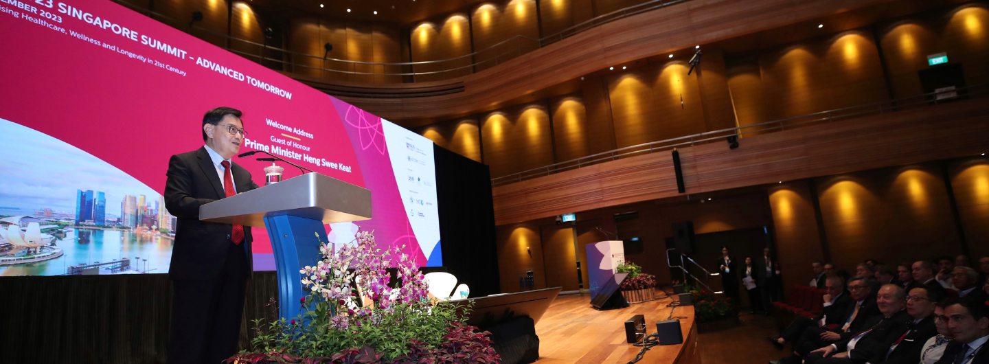 Heng Swee Keat at Singapore Summit, auditorium setting with attendees.